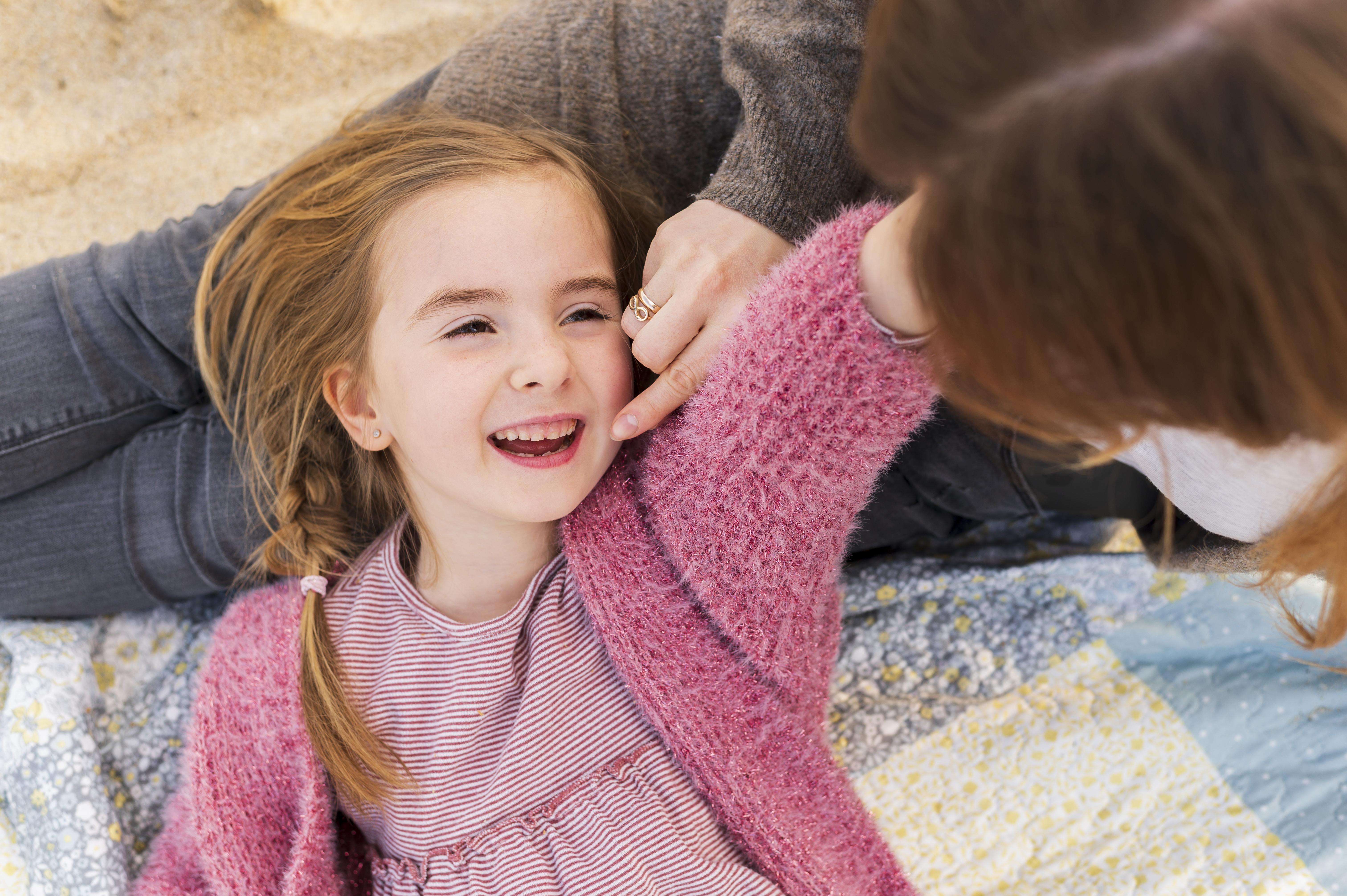mother playing with girl Pediatric Hearing Evaluations at DR GEORGE hearing centers